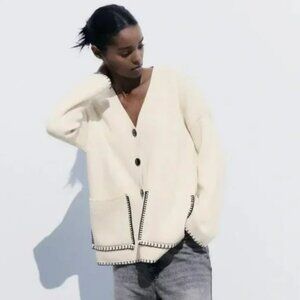 Brand new Zara never worn. Lovely cream/ivory cardigan with black stitching.